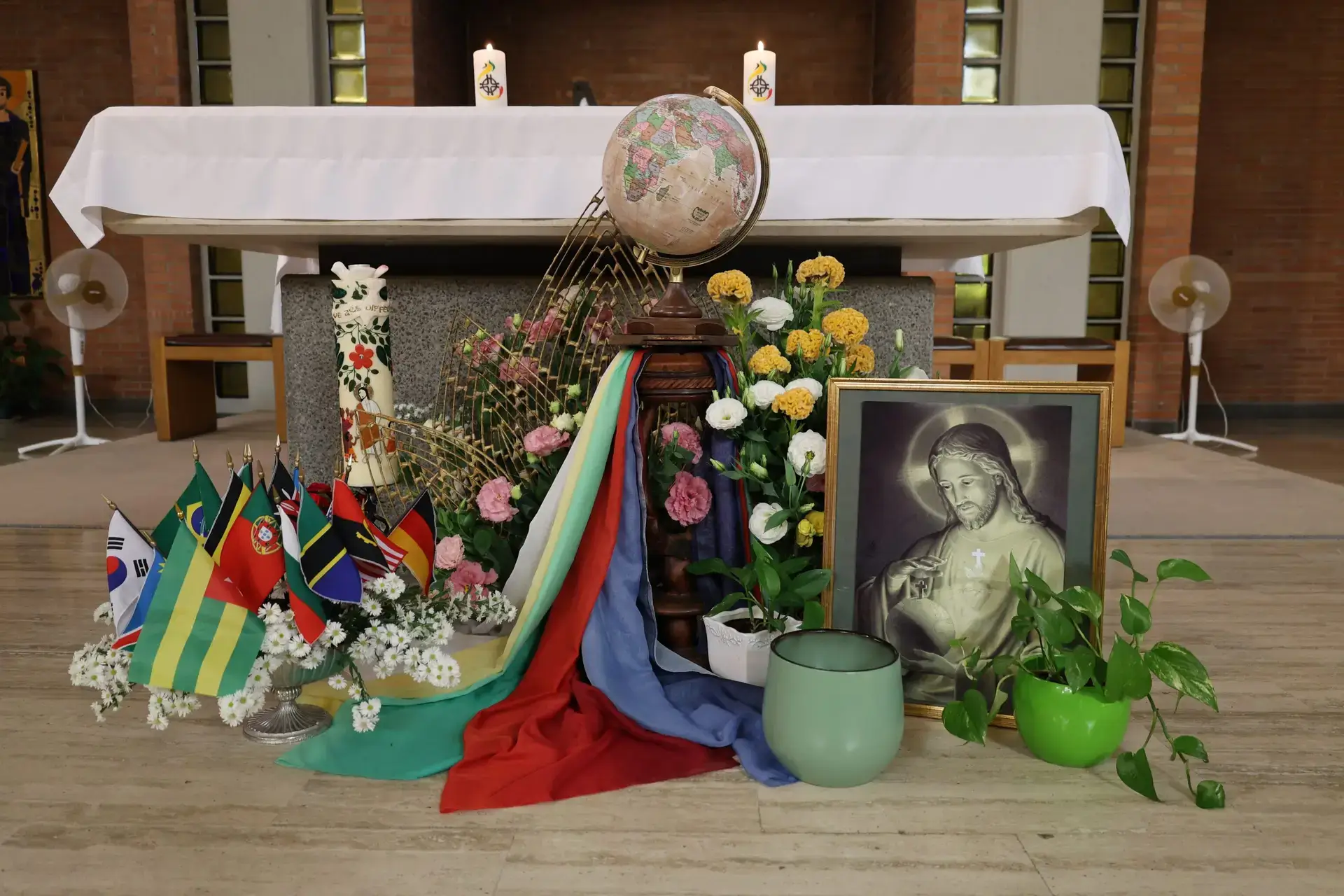 Devotional display with ribbons, flowers, and framed portrait